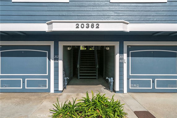 Front view of a building with two garages and a numbered address 20362.