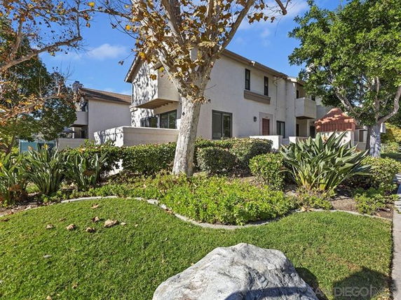 Front view of a two-story house with a garden.