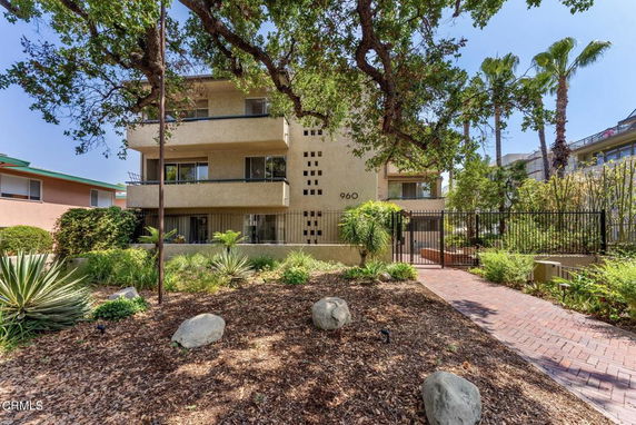 Front view of a multi-story residential building with balconies.
