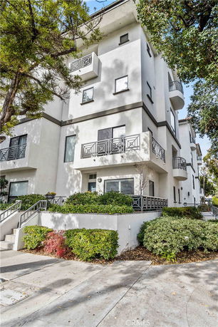 Front view of a multi-story modern building with balconies.