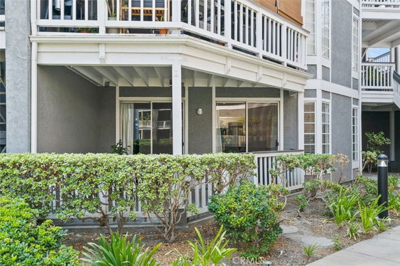 Front view of a multi-story residential building with balconies.