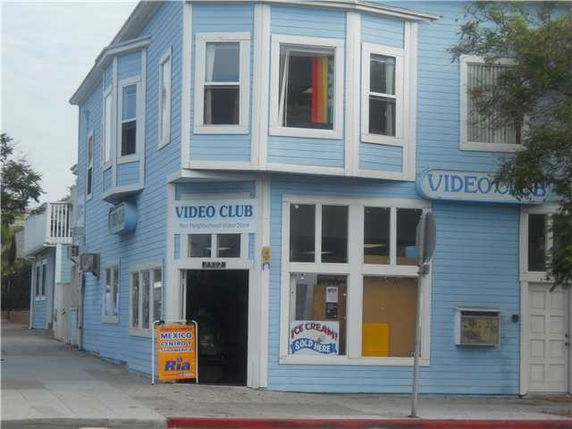 Front view of a blue two-story commercial building labeled 'VIDEO CLUB'.