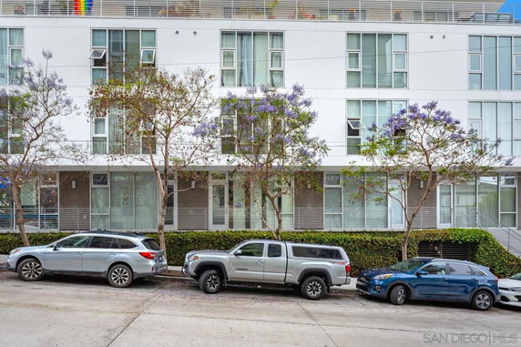 Front view of a multi-story building with a modern design and large windows.