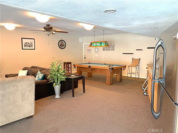 Room with a pool table and seating area