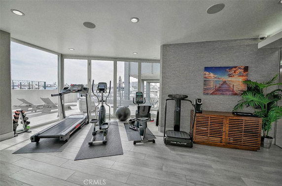 Indoor gym area with exercise equipment and glass walls.