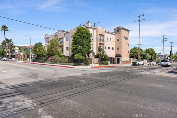 Front view of a multi-story building at a street intersection.