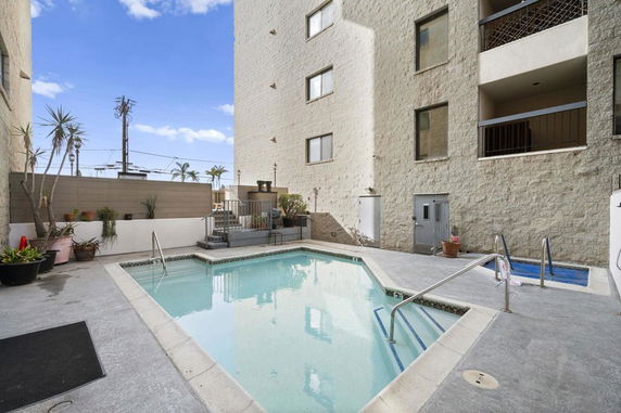 Outdoor area with a swimming pool adjacent to a building.