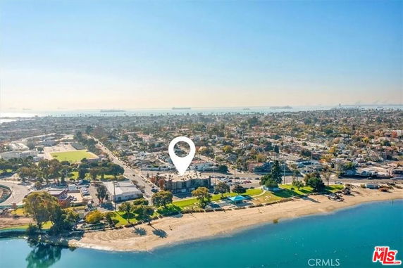 Wide aerial view of a coastal town and beach.