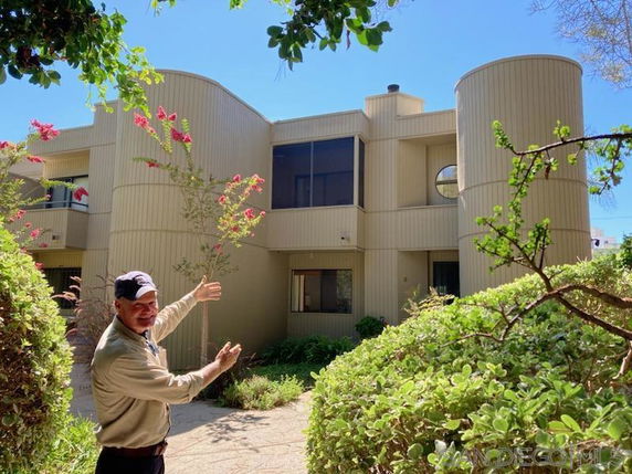 Front view of a two-story building with rounded architectural elements.