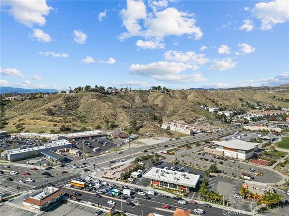 Elevated view of a commercial area with surrounding hills and mountains.