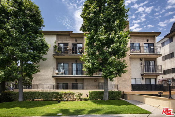 Front view of a multi-story residential building with balconies.