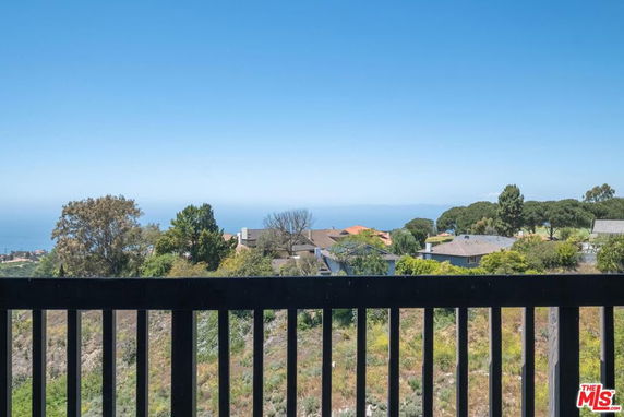 Panoramic view of residential area with ocean in the background.