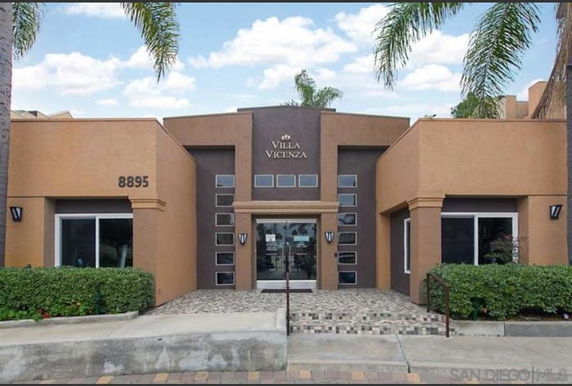 Front view of a two-story building with modern architecture and large windows.