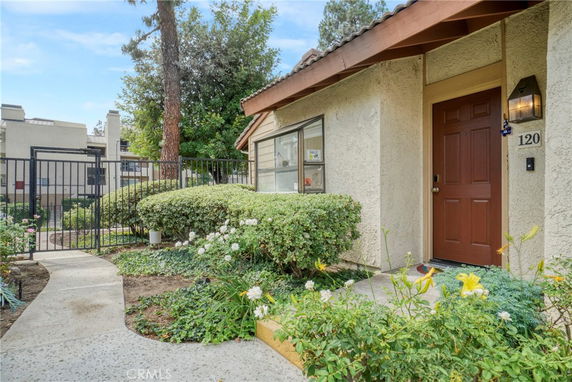 Front view of a single-story house with a front door and garden