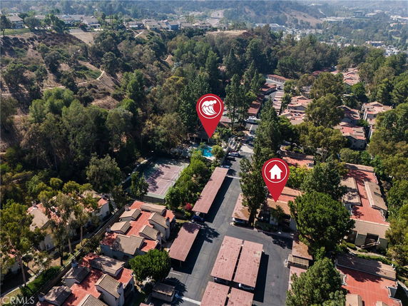 Aerial view of a residential area with pathways and surrounding greenery.