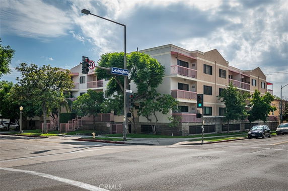 Corner view of a multi-story residential building with balconies.