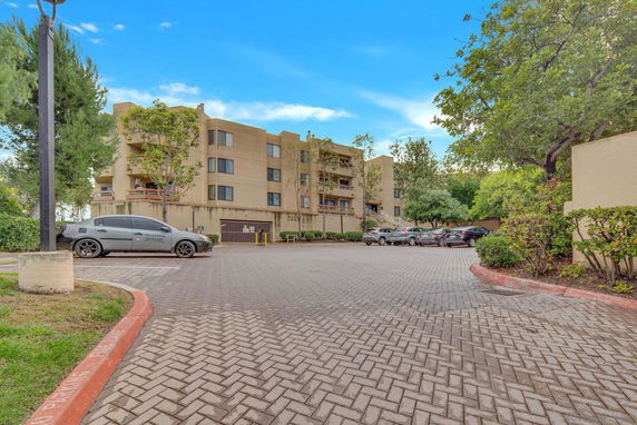 Outdoor parking area in front of a multi-story building.