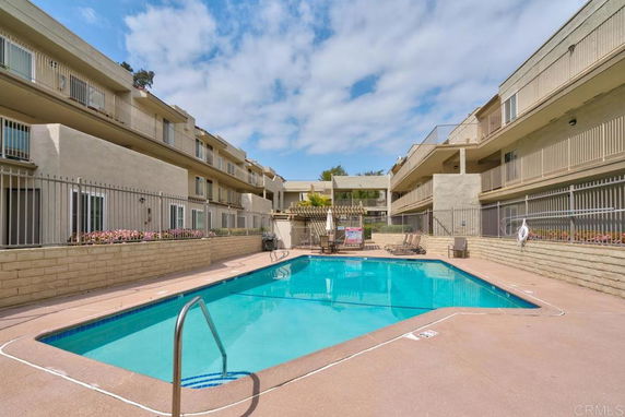 Swimming pool in the courtyard of a multi-story apartment building.
