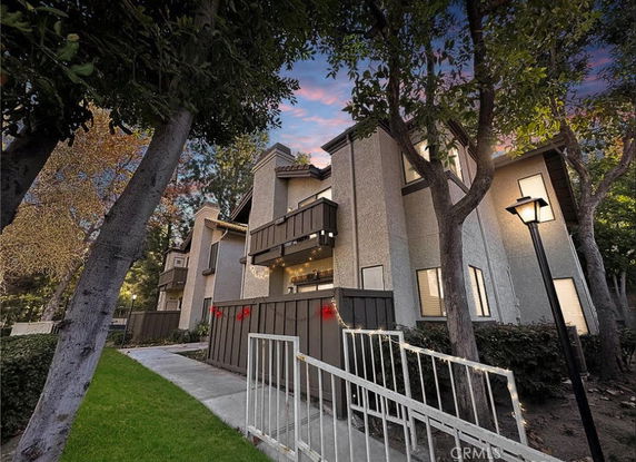 Front view of a multi-story residential building with balconies.