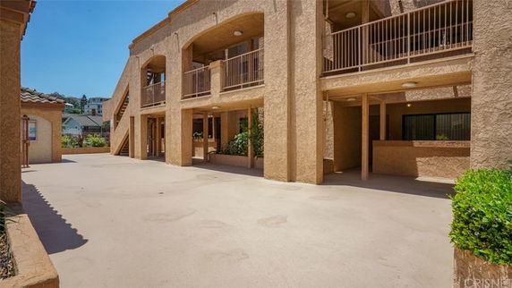 Front view of a multi-story building with balconies and staircases.