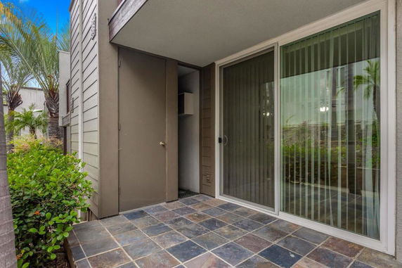 Outdoor view of a modern building entrance with sliding glass door.