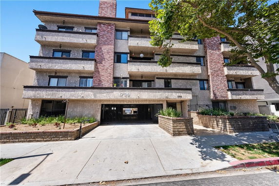 Front view of a multi-story residential building with balconies.