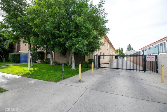 Front view of a residential building with gated entrance.