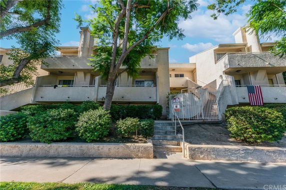Front view of a multi-story residential building with balconies.