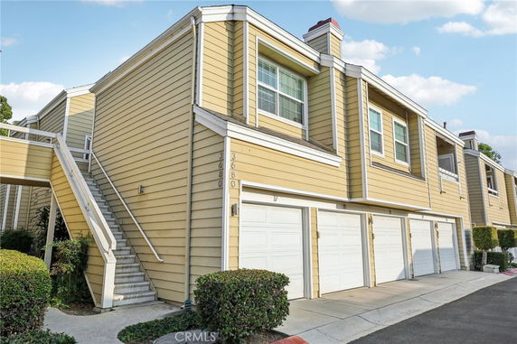 Front view of a multi-story house with attached garages.