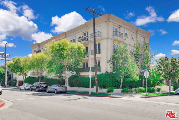 Front view of a multi-story apartment building with balconies.