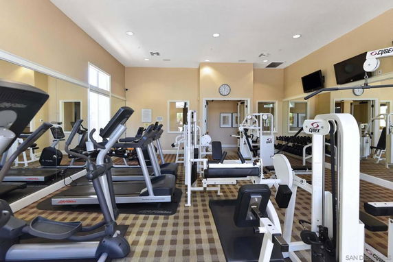 Indoor gym area with various exercise equipment.