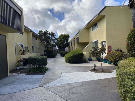 Front view of two-story buildings with a walkway in between.