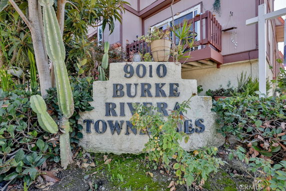 Front view of a townhouse complex with a sign reading '9010 Burke Riviera Townhomes'.