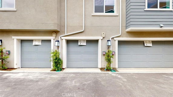 Row of residential garages with closed doors.