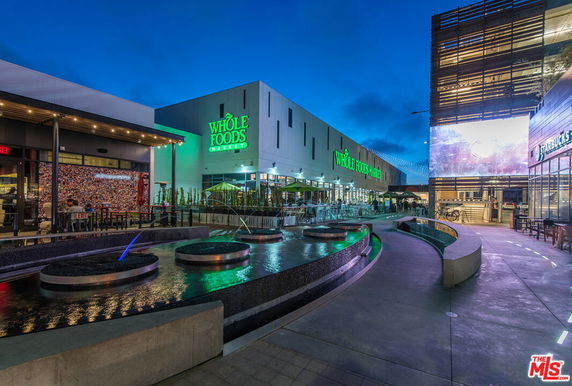 Front view of a retail complex with Whole Foods Market and Starbucks.