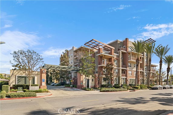 Front view of a multi-story residential building with a modern design and balconies.