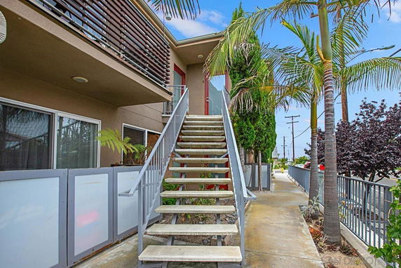Front view of a modern two-story building with an exterior staircase.