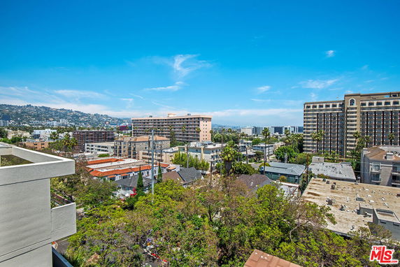 Panoramic view of urban area with high-rise buildings under a clear blue sky.
