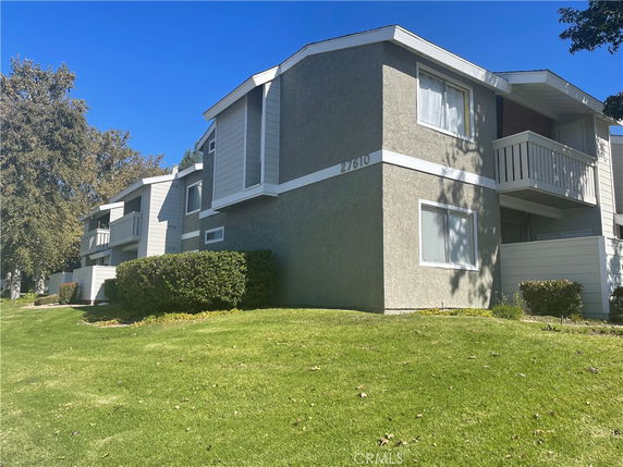 Front view of a multi-story residential building with balconies.