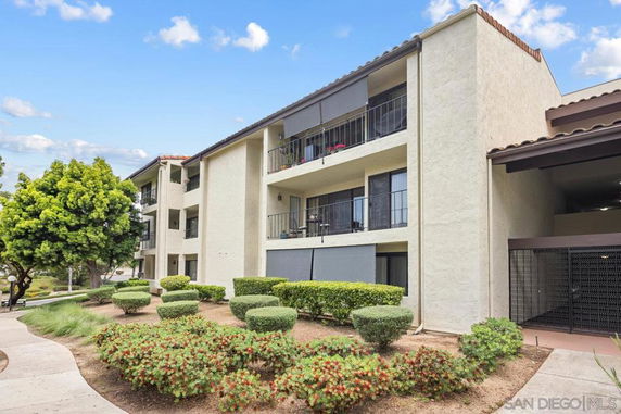 Front view of a multi-story residential building with balconies.