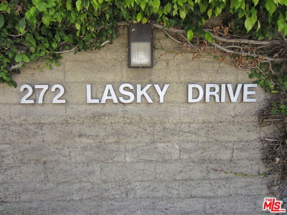 Exterior wall with the address '272 LASKY DRIVE' and a light fixture.