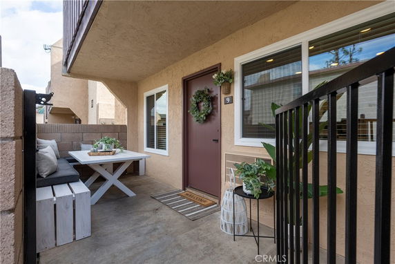 Front view of a house entry with a small patio area and decorations.