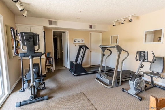 Indoor gym area with exercise equipment including treadmills and stationary bikes.