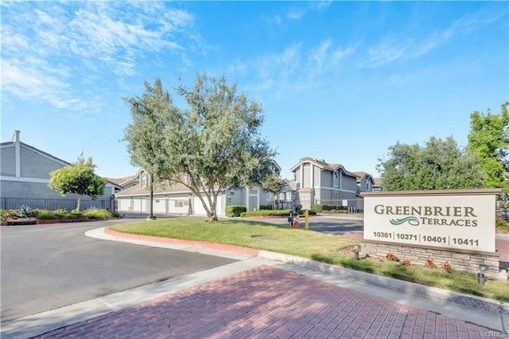 Front view of a residential complex with multiple two-story buildings and a sign reading 'Greenbrier Terraces'.