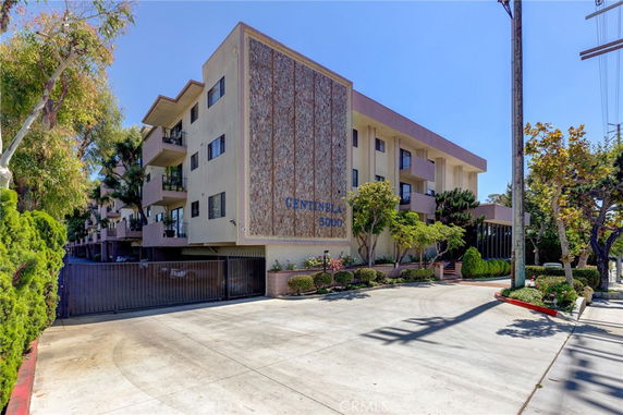 Front view of a multi-story apartment building with balconies.