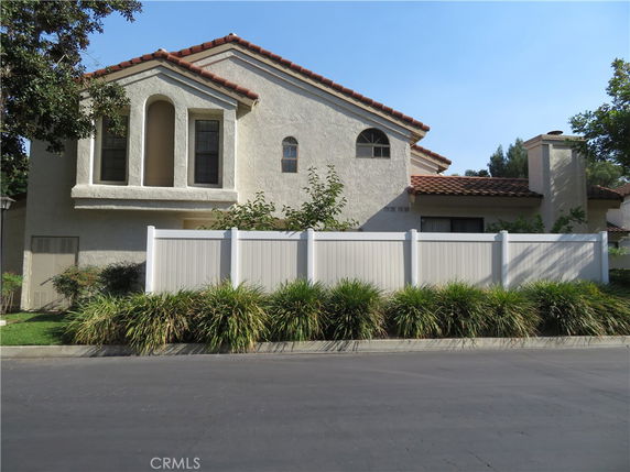 Front view of a two-story house with a tiled roof.