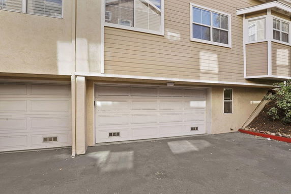 Outdoor view of a building with double garage doors.