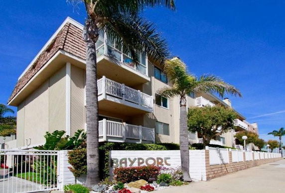 Front view of a multi-story residential building with balconies.