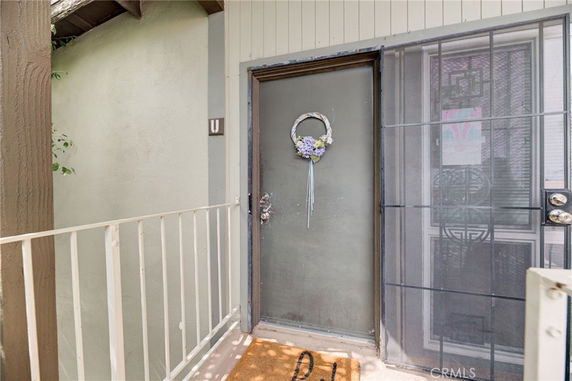 Entrance view of a building unit with door and railing.