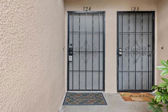 Entrance of a building with two doors numbered 123 and 124.